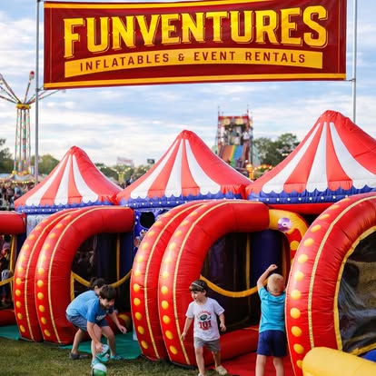 Kids playing at inflatable carnival games under a FunVentures banner