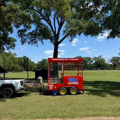 A branded FunVentures dunk tank on a park lawn